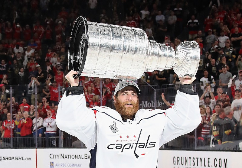Braden Holtby holding up the Stanley Cup.