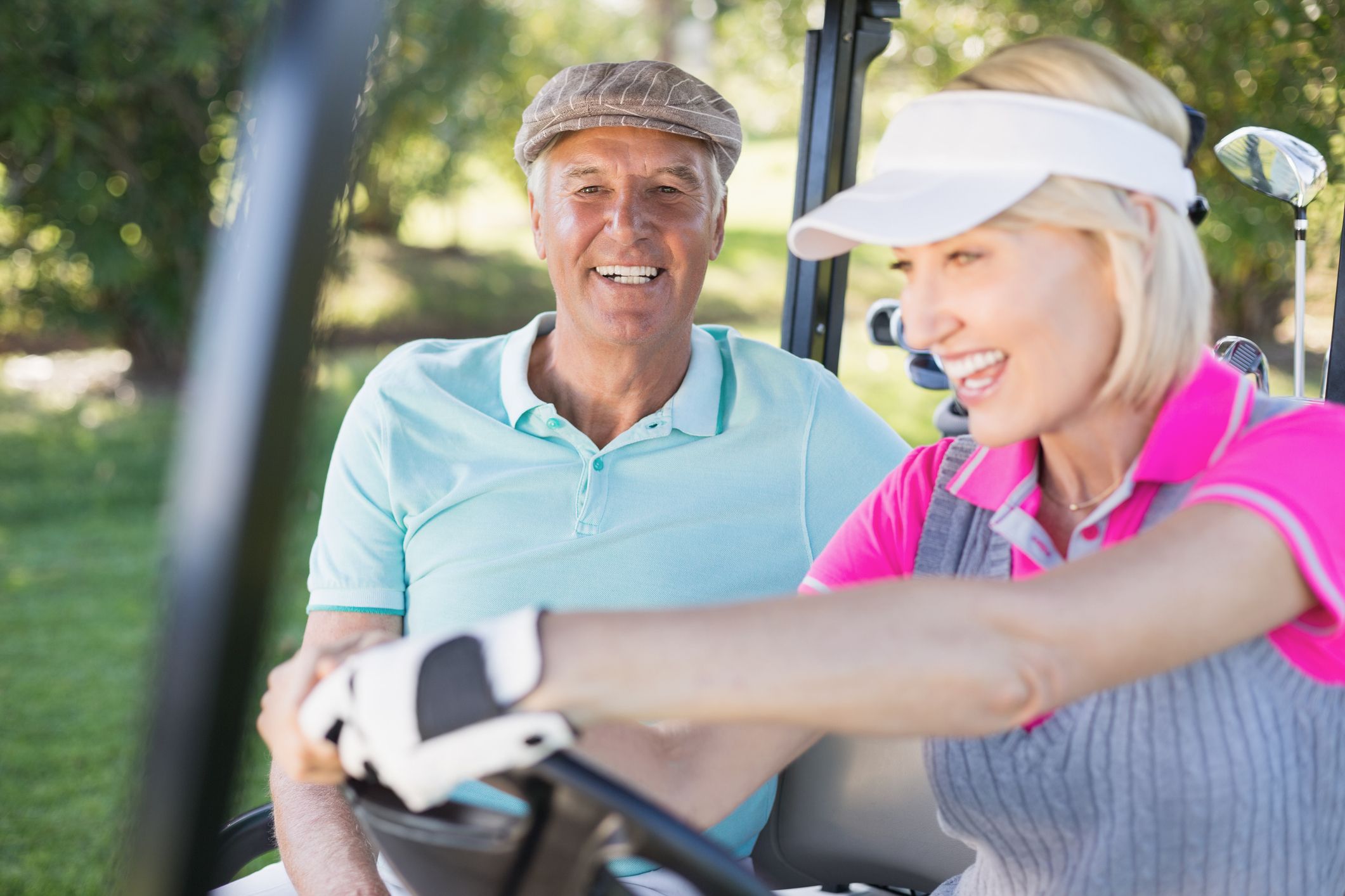 Mature couple enjoying in golf cart