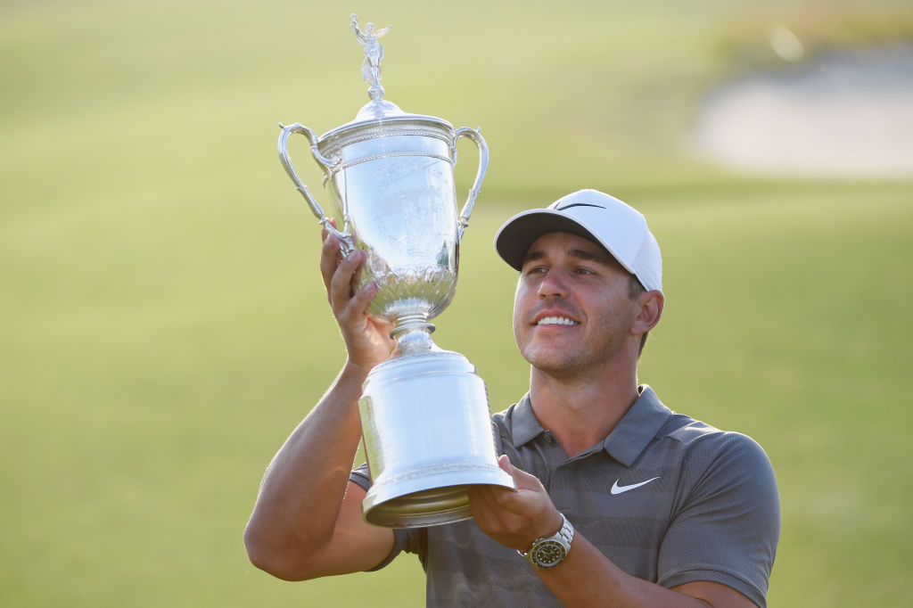 Brooks Koepka of the United States celebrates with the U.S. Open Championship trophy after winning the 2018 U.S. Open at Shinnecock Hills Golf Club on June 17, 2018 in Southampton, New York. 