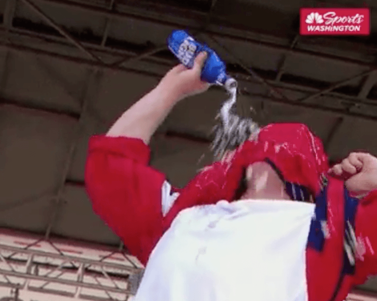 A fan drinking beer through his shirt.
