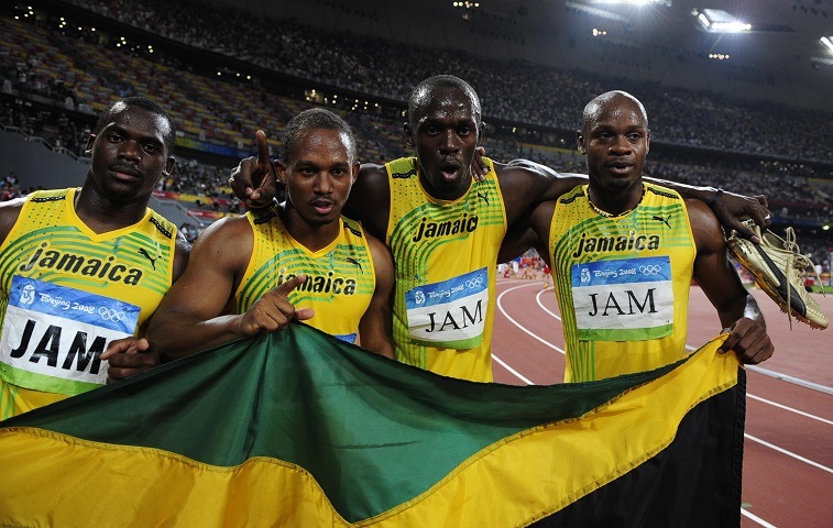 Jamaica's Nesta Carter, Michael Frater, Usain Bolt and Asafa Powell celebrate after winning the men's 4?100m relay final at the "Bird's Nest" National Stadium during the 2008 Beijing Olympic Games on August 22, 2008. 