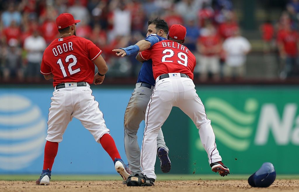 Adrian Beltre holds Jose Bautista back after Rougned Odor punches him
