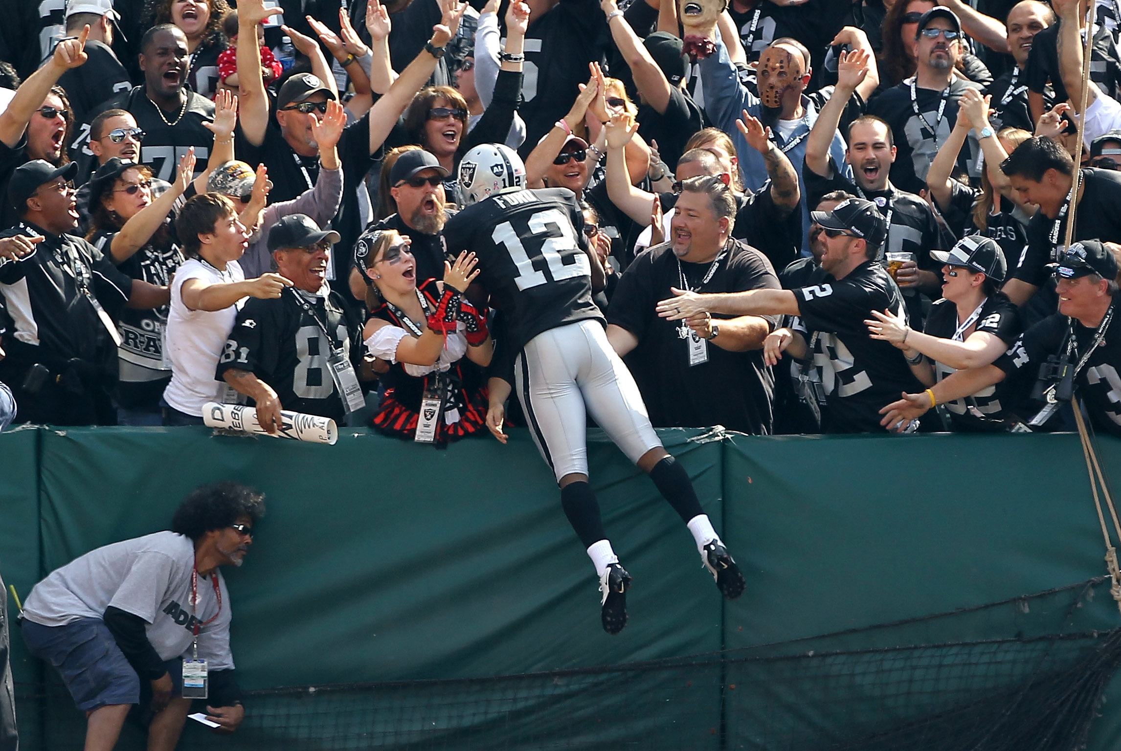 Jacoby Ford jumps into the stands in Oakland.