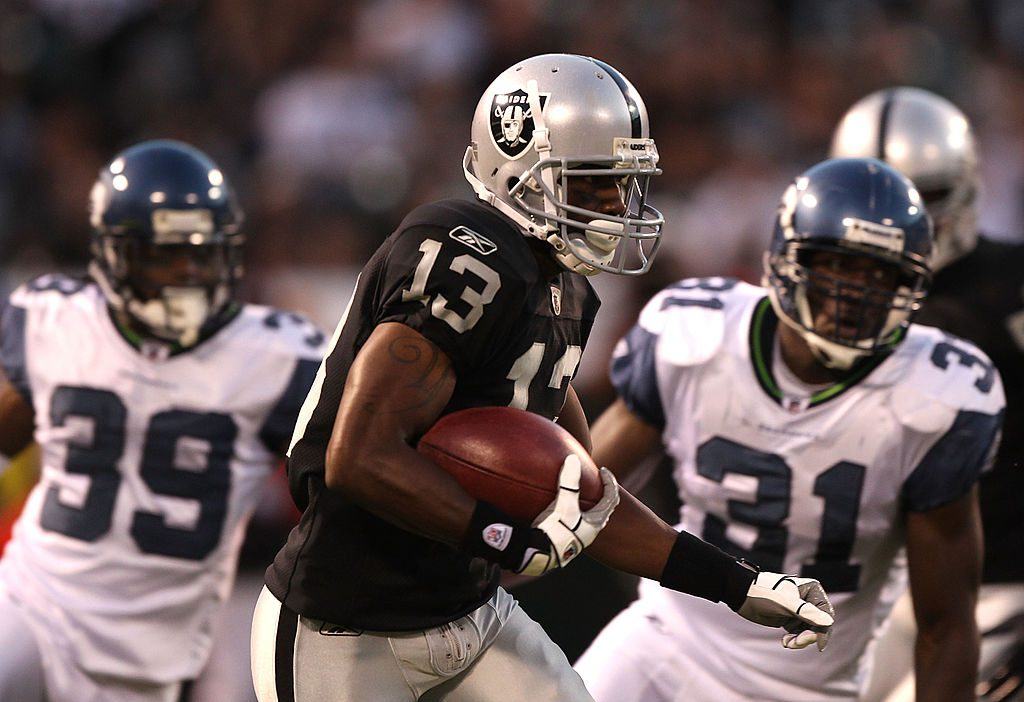 Yamon Figurs of the Oakland Raiders eludes Seattle Seahawks defenders.