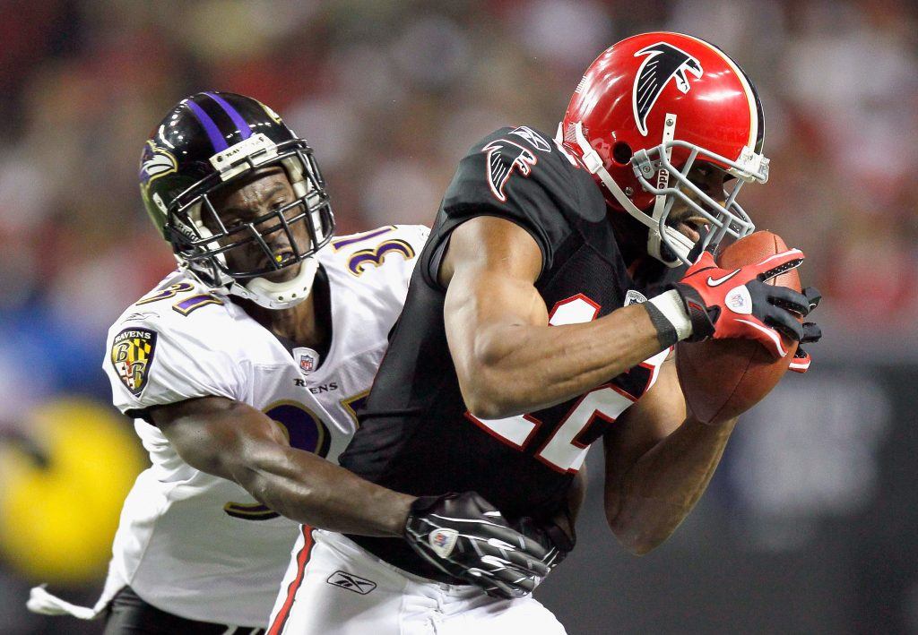 Fabian Washington tackles Michael Jenkins