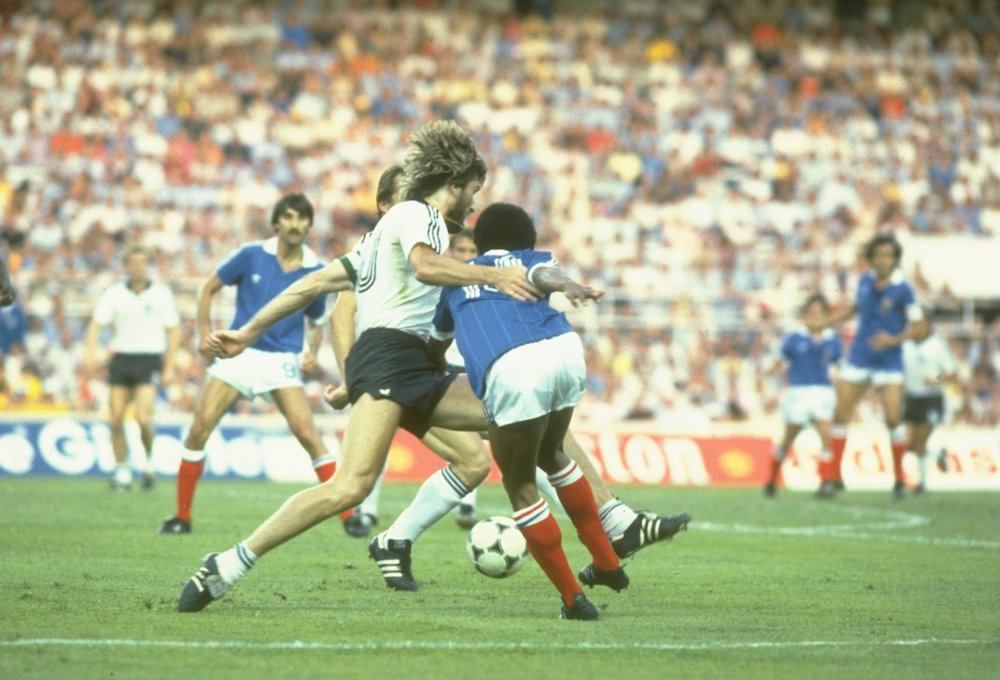 Manni Kaltz (left) of West Germany tackles Jean Tigana (right) of France for the ball during the World Cup Semi Finals match in 1982