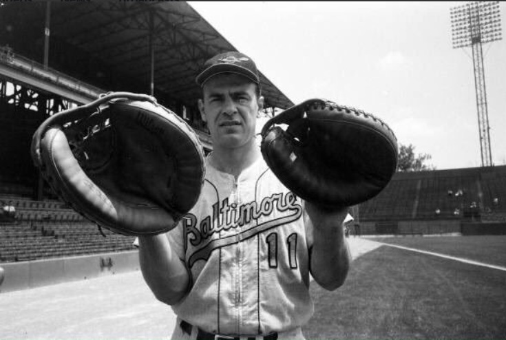 Baltimore Orioles catcher Gus Triandos compares mitts