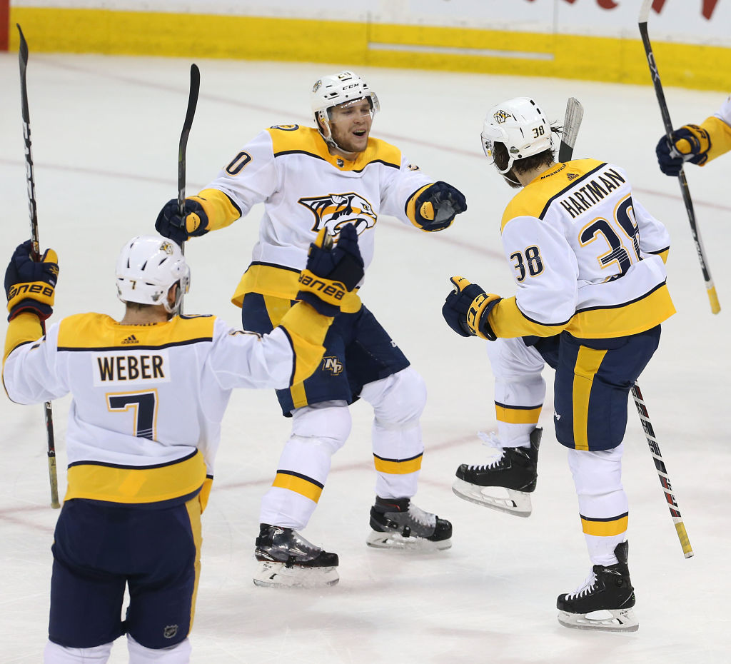 Ryan Hartman #38, Miikka Salomaki #20 and Yannick Weber #7 of the Nashville Predators