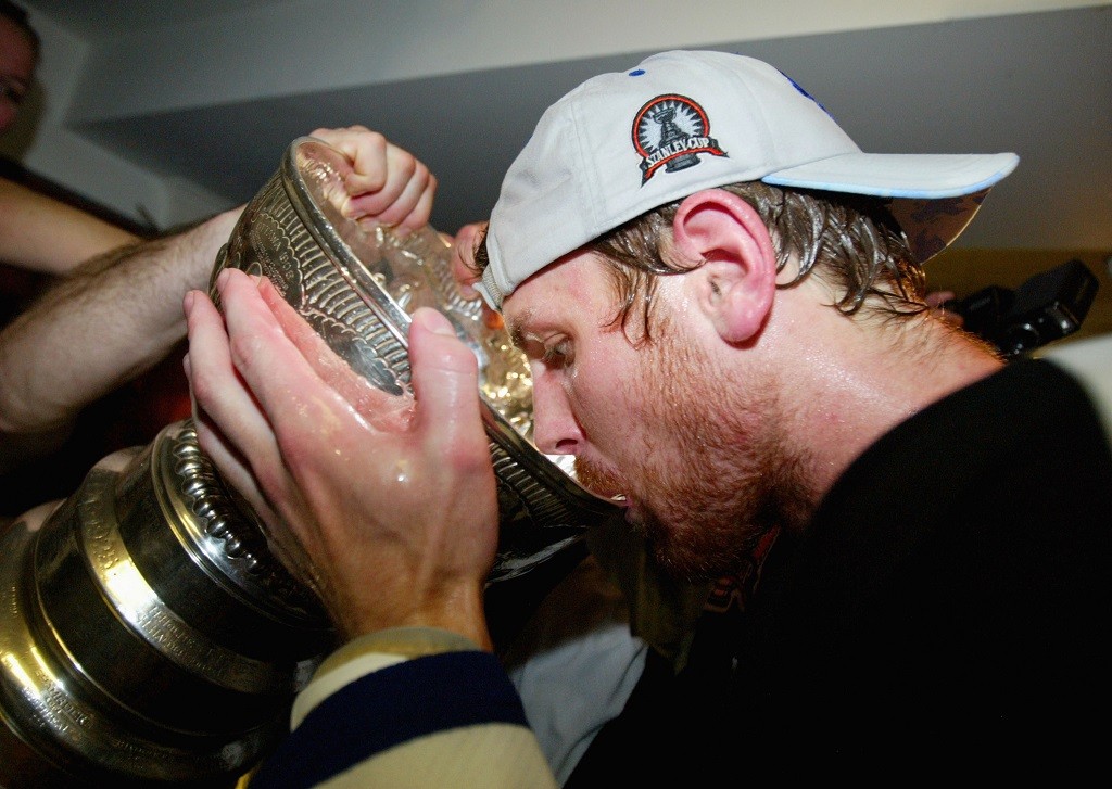 Former player Brad Richards drinks beer from the Stanley Cup