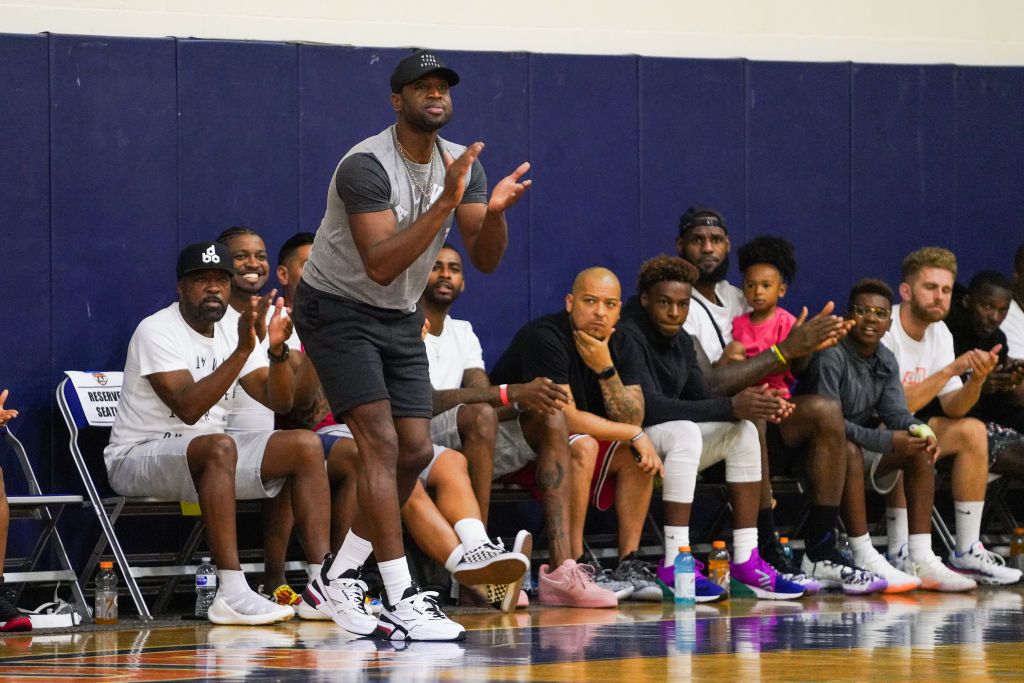 Former teammates Dwyane Wade (standing) and LeBron James (sixth from right with backwards hat) will be seeing a lot of each other when their sons play on the same high school basketball team.