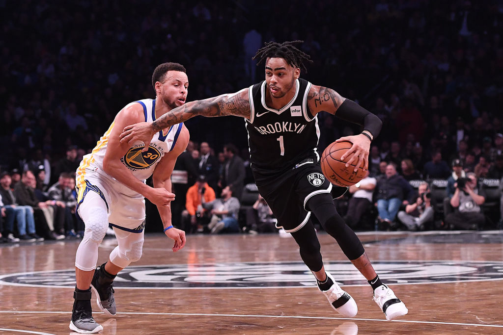 D'Angelo Russell drives by his new teammate Steph Curry