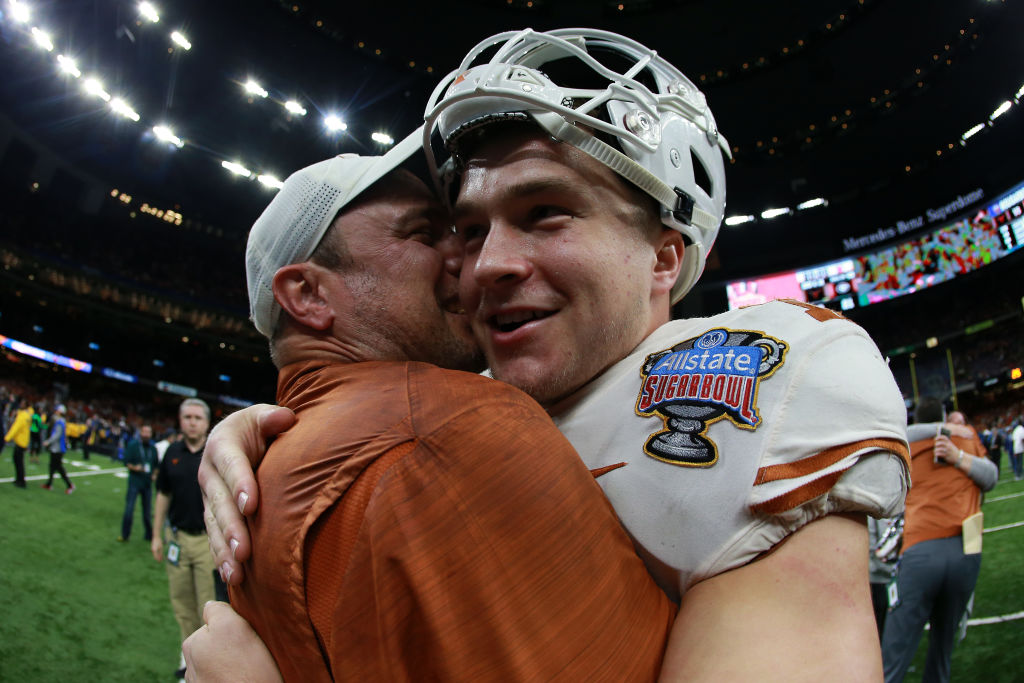 Head coach Tom Herman celebrates with Sam Ehlinger #11