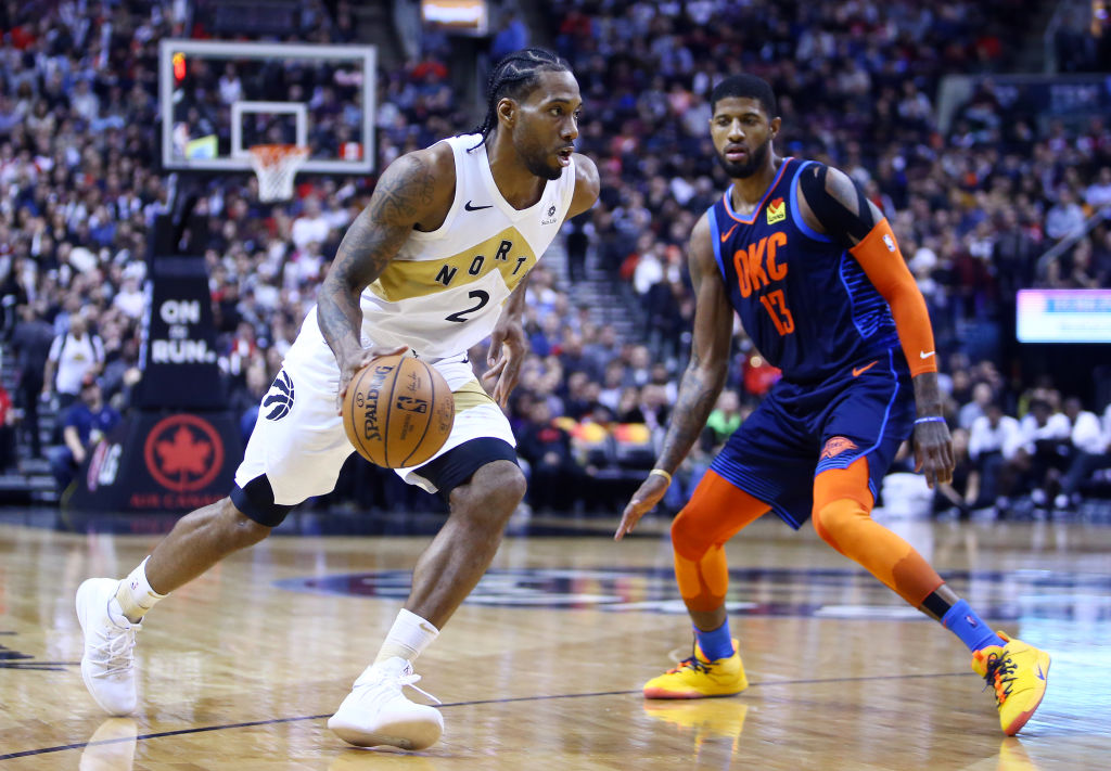 Kawhi Leonard drives in on Paul George