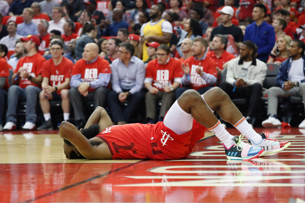 James Harden lays on the court after a hard foul