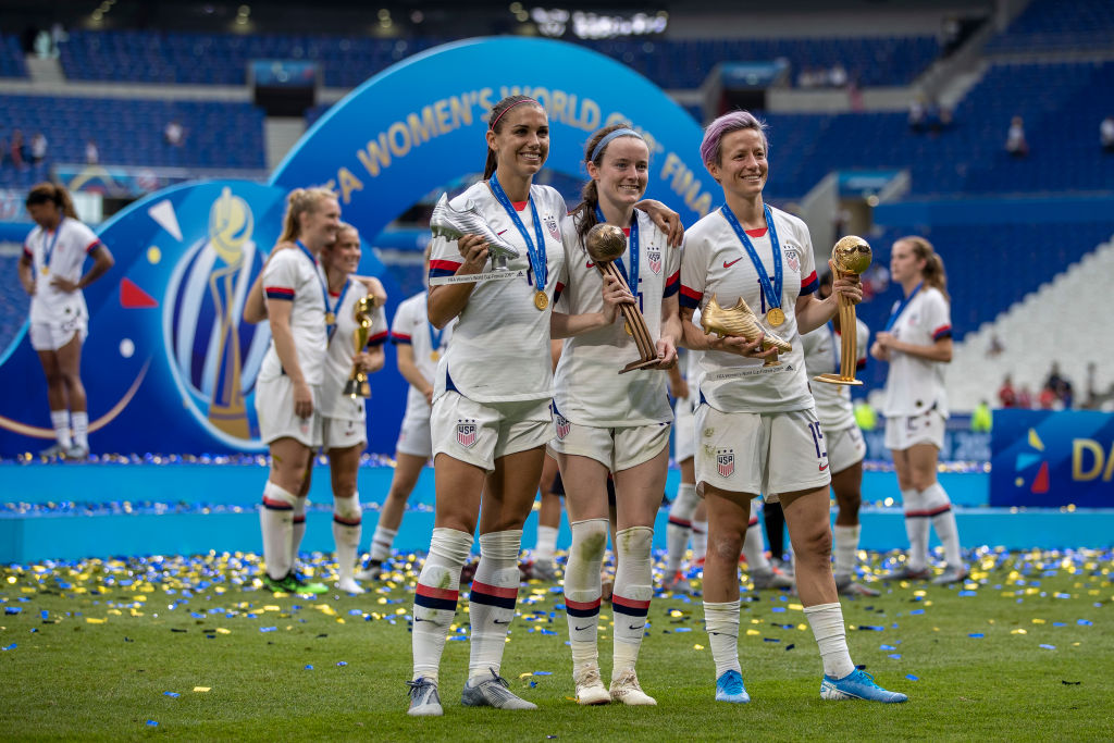 Megan Rapinoe, Alex Morgan, and Rose Lavelle pose with their trophies