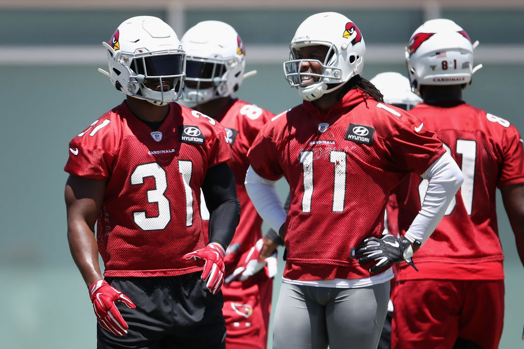 Arizona Cardinals players David Johnson (left) and Larry Fitzgerald should figure prominently in head coach Kliff Kingsbury's offense.