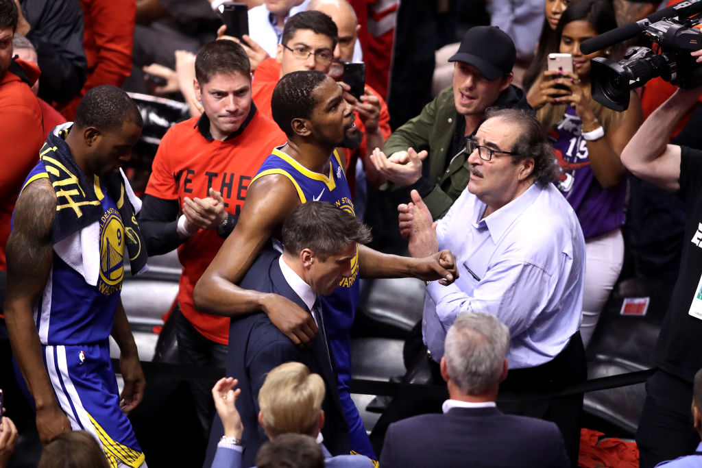Kevin Durant #35 of the Golden State Warriors is assisted off the court