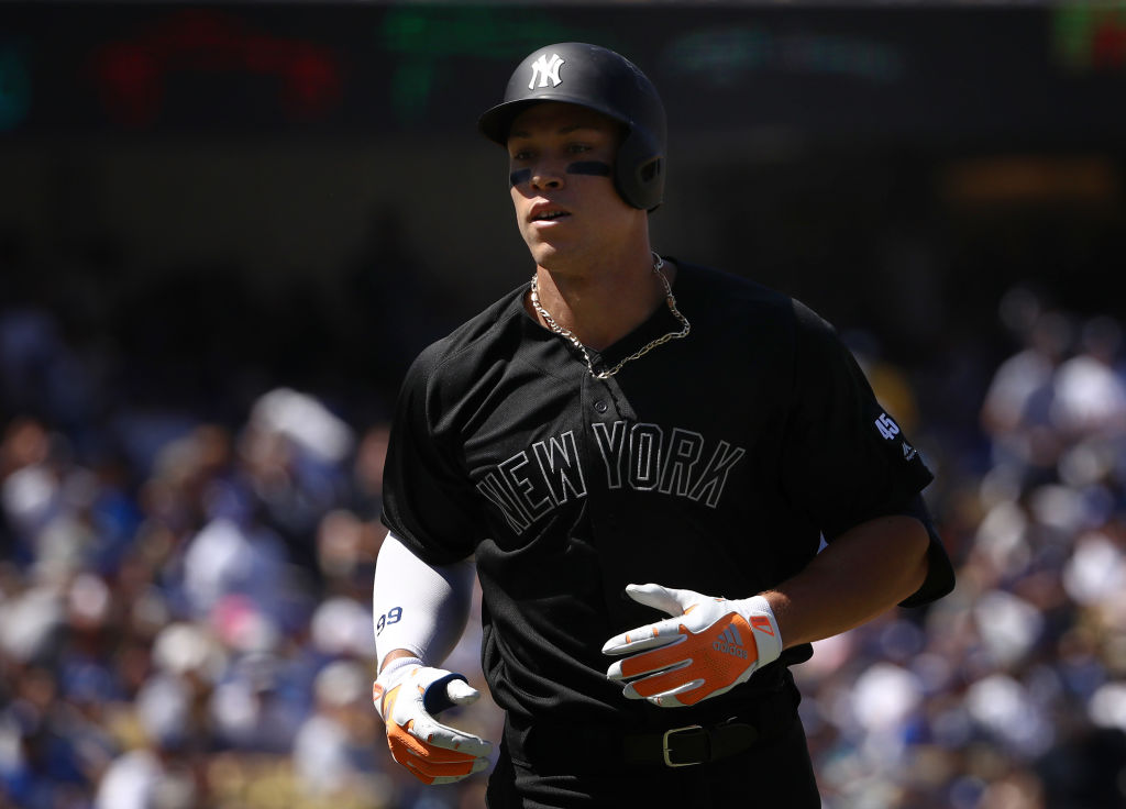 Aaron Judge #99 of the New York Yankees jogs toward the dugout