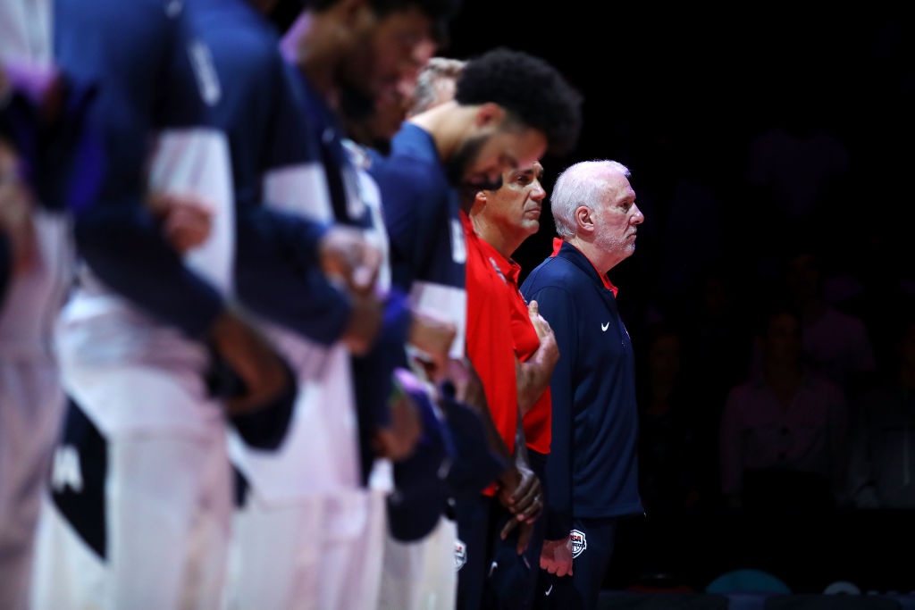 Gregg Popovich stands with Team USA during the national anthem