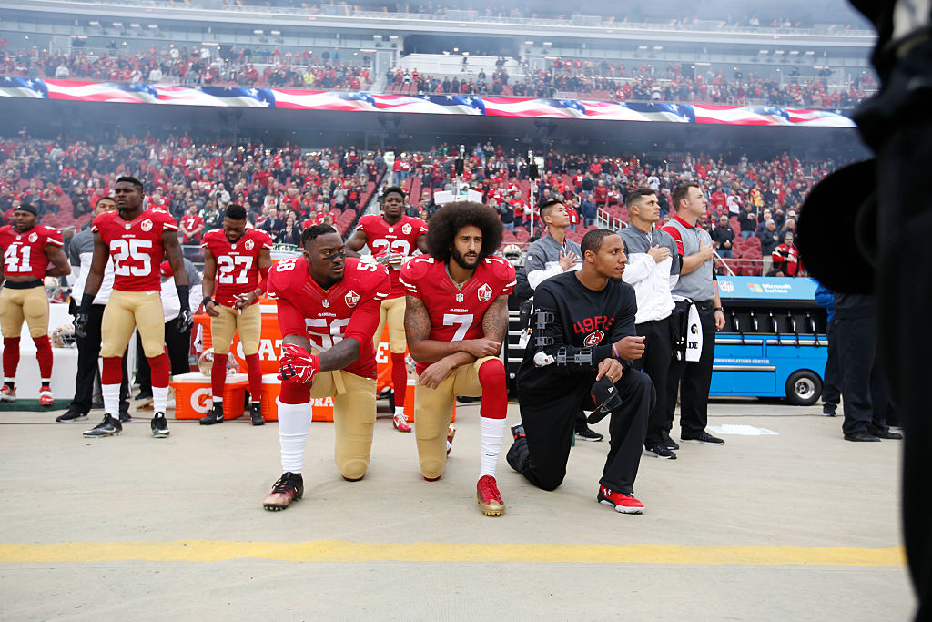 Colin Kaepernick #7 and Eric Reid #35 of the San Francisco 49ers kneel