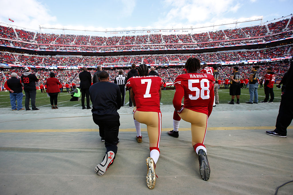 Colin Kaepernick #7 and Eli Harold #58 of the San Francisco 49ers