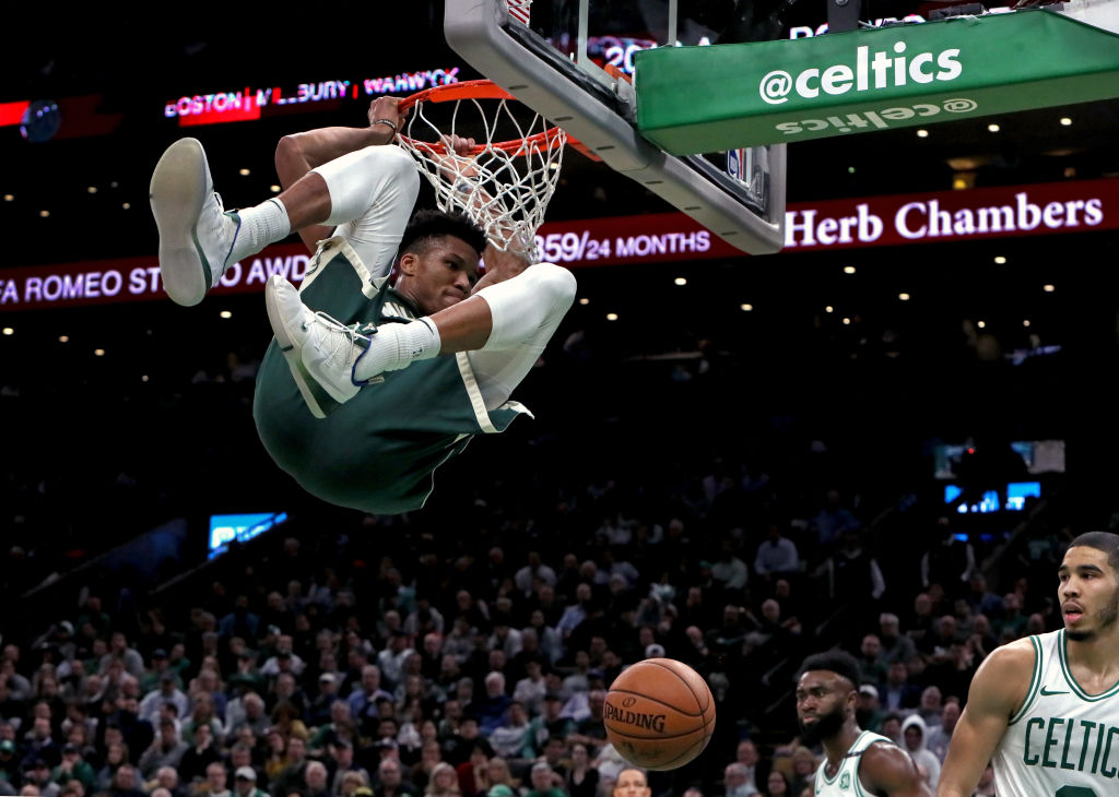 Giannis Antetokounmpo (dunking) and younger brother Kostas Antetokounmpo are at two different stages of the NBA journeys.