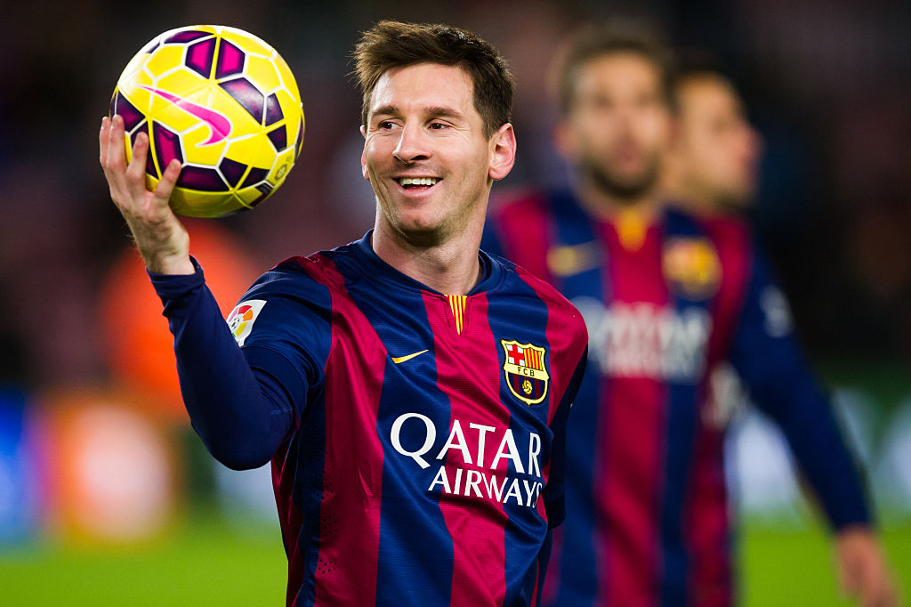 Lionel Messi holds the soccer ball between plays