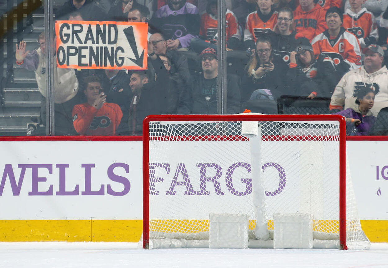 A Flyers fan holds up a sign pointing to the empty net after the Vancouver Canucks pulled their goalie.