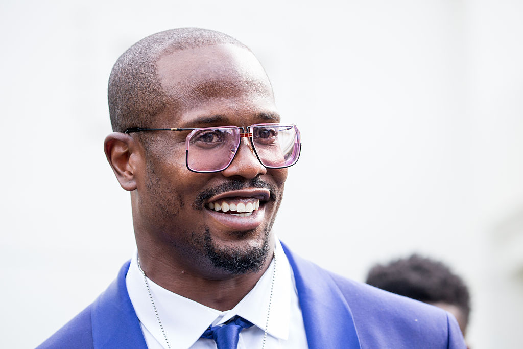 Close up of Von Miller smiling and wearing a blue suit