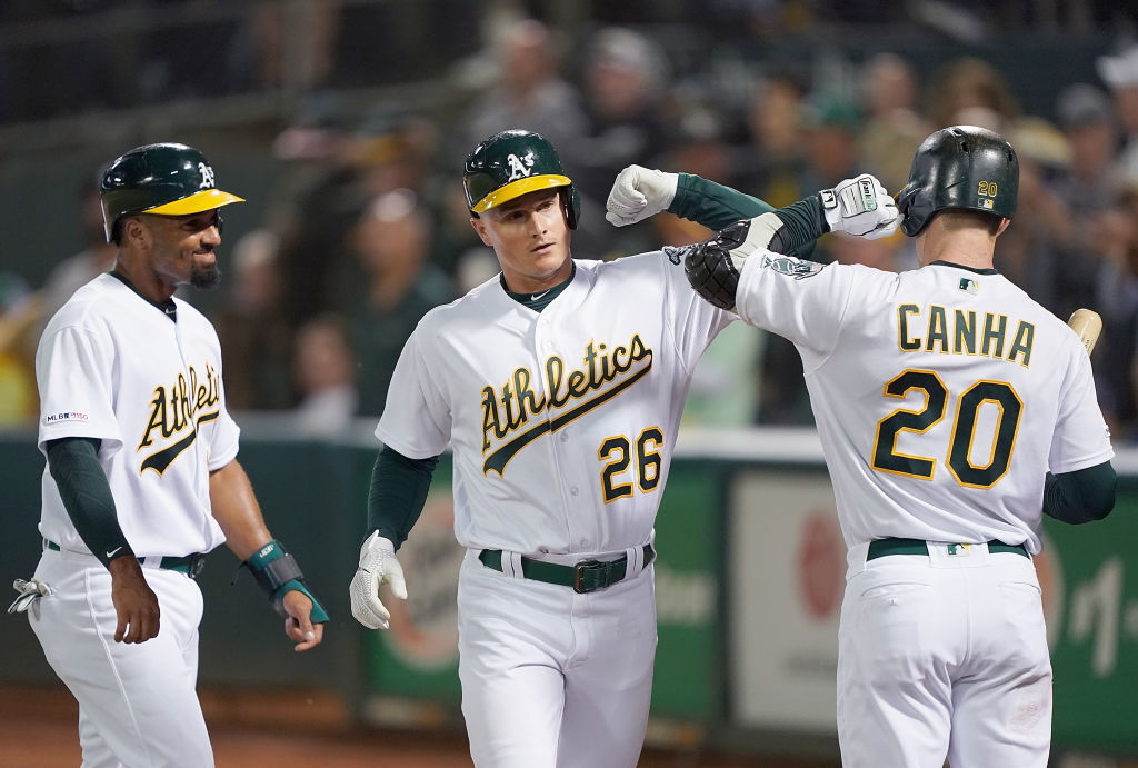 Matt Chapman celebrates with his teammates after hitting a home run