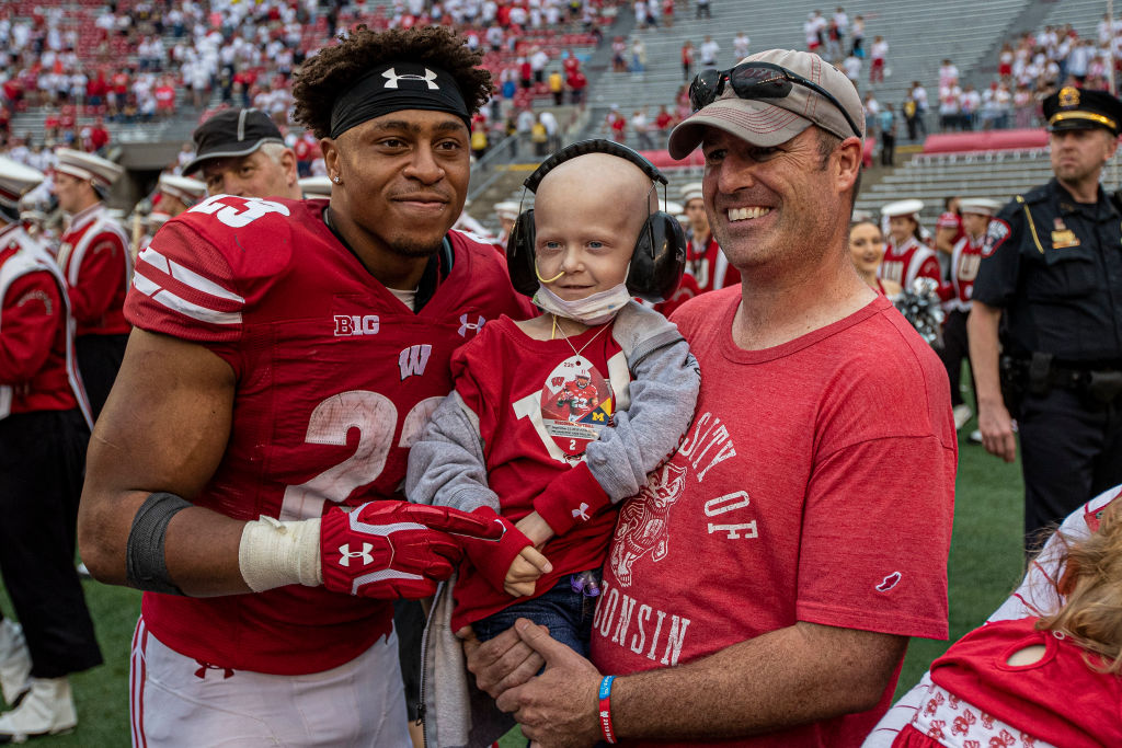 Jonathan Taylor poses with a fan after Wisconsin's 35-14 win over Michigan