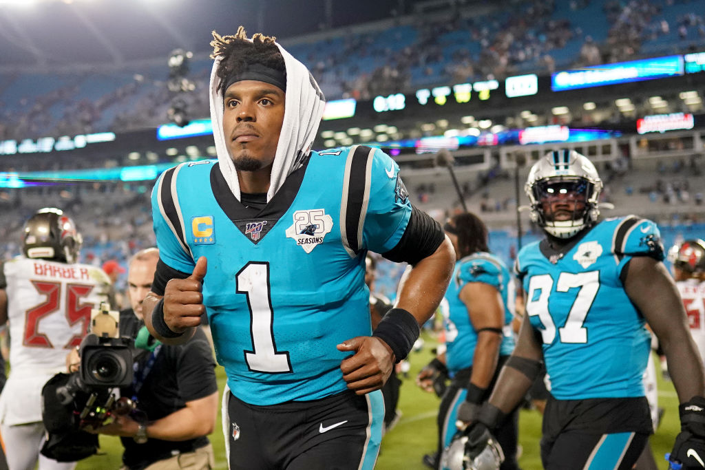Cam Newton leaves the field after a disappointing loss to Tampa Bay