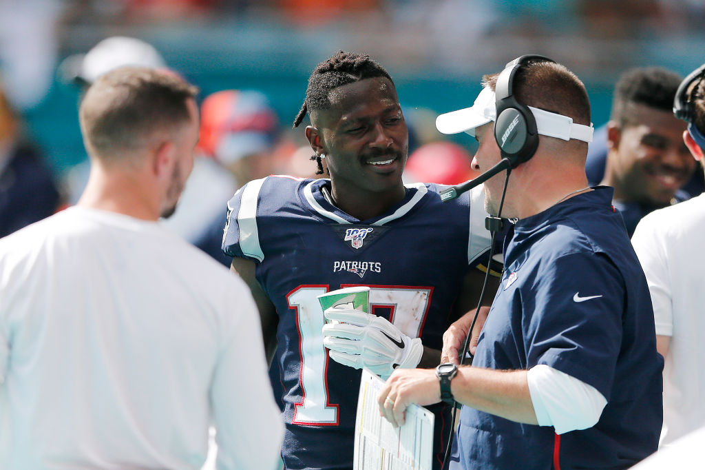 Antonio Brown #17 of the New England Patriots talks with offensive coordinator Josh McDaniels