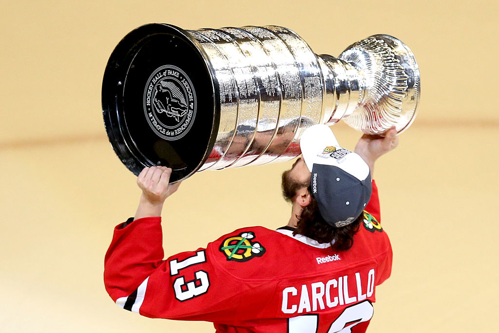 Daniel Carcillo #13 of the Chicago Blackhawks celebrates by kissing the Stanley Cup