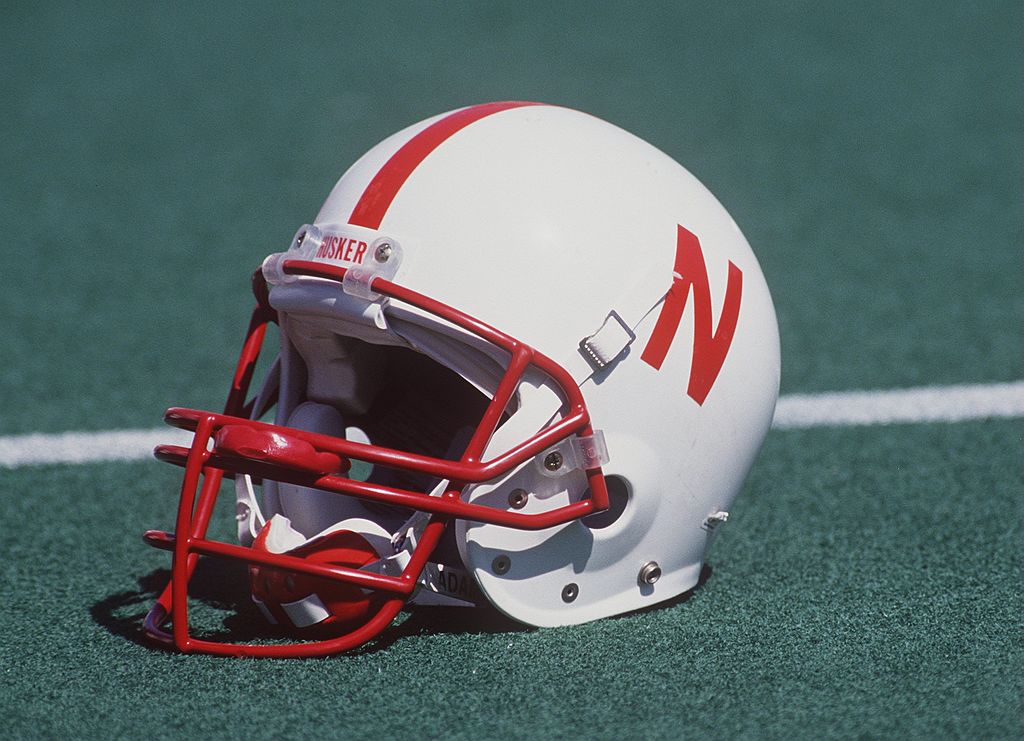A Nebraska football helmet sitting on the field