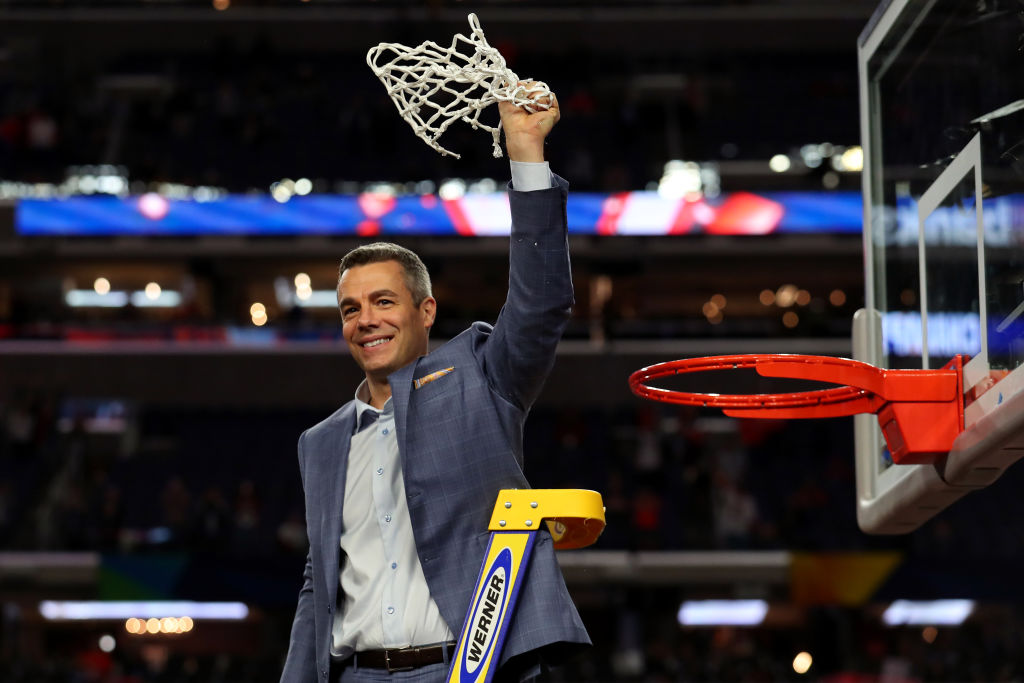 Virginia basketball coach Tony Bennett cutting down the basketball net.
