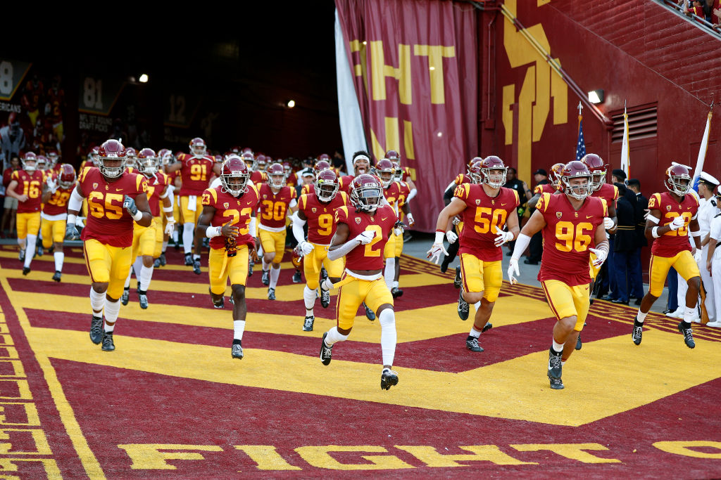 The USC Trojans running onto the field before their upset win over the Utah Utes