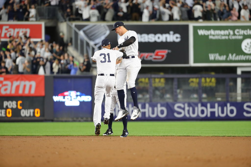 Aaron Hicks and Aaron Judge of the New York Yankees celebrate after the Yankees won the American League Wild Card game in 2018