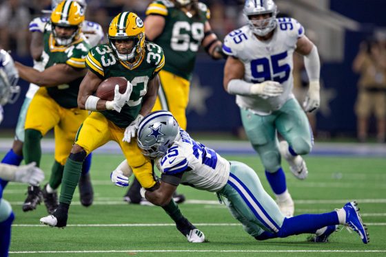 NFL running back Aaron Jones carries the ball against the Dallas Cowboys.