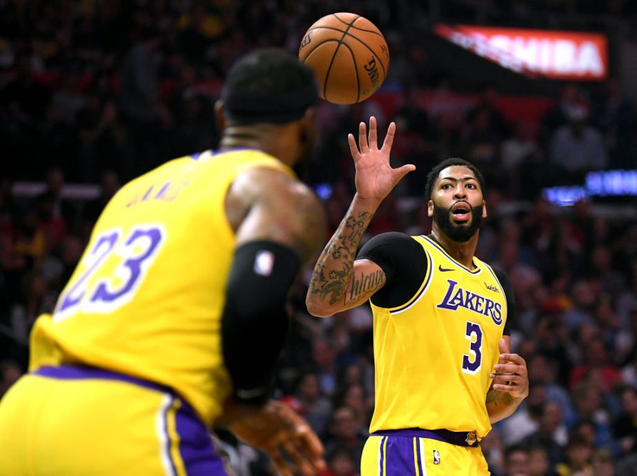LeBron James passes the ball to his new Lakers teammate Anthony Davis.