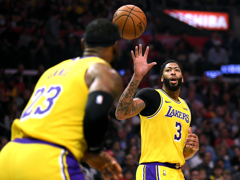 LeBron James passes the ball to his new Lakers teammate Anthony Davis.