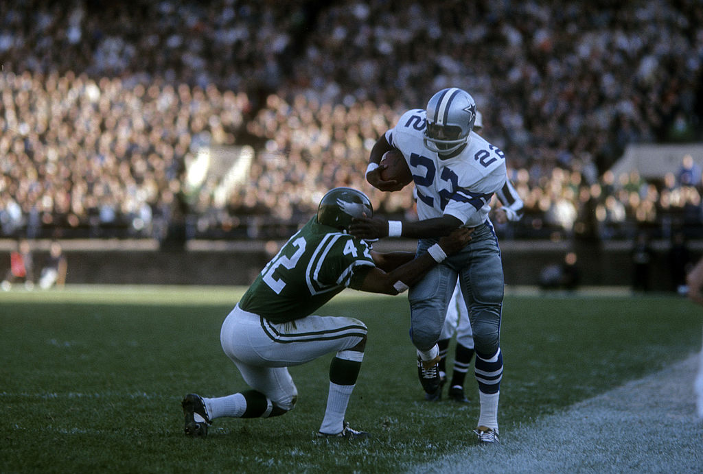 Cowboys' Bob Hayes runs passed a defender.