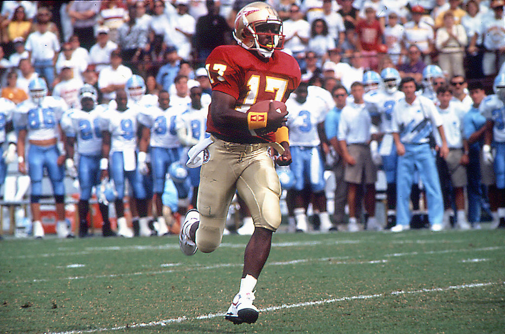 Charlie Ward of the Florida State Seminoles runs the ball downfield