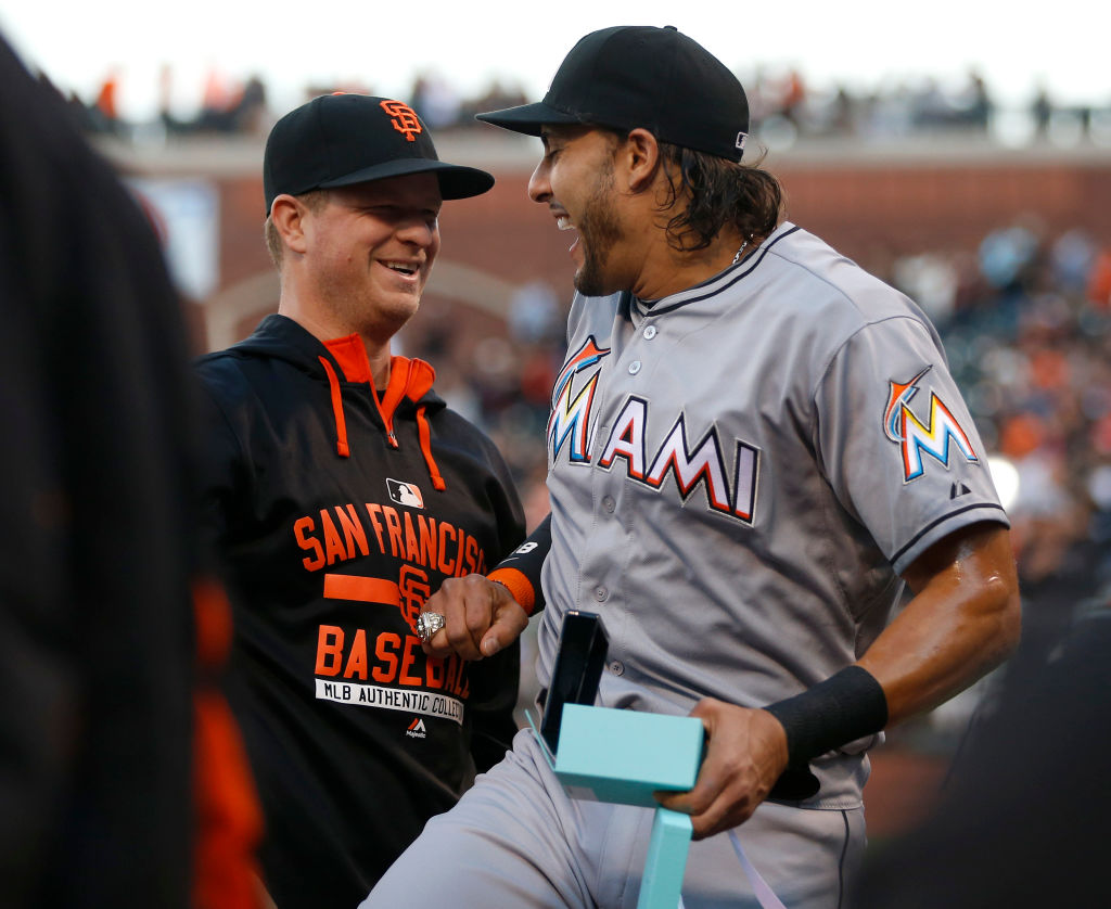 Miami Marlins' Michael Morse and former San Francisco Giants player jokes with Giants pitcher Matt Cain after he received his 2014 World Series ring