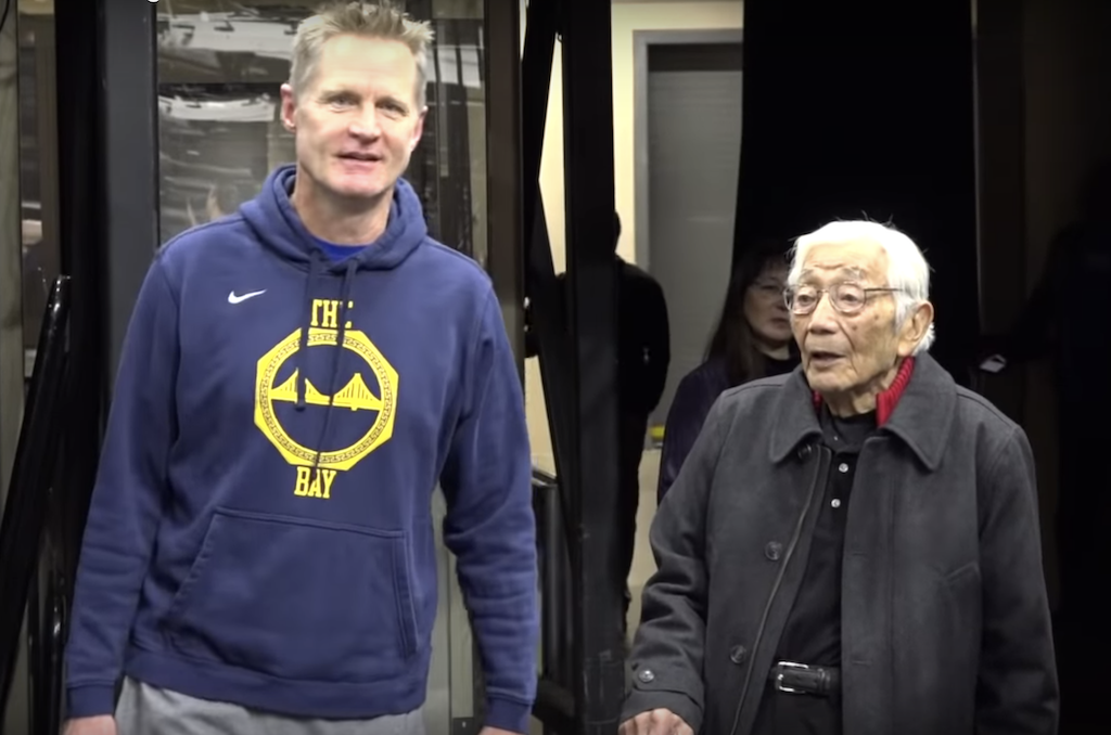 Warriors coach Steve Kerr speaks with former NBA player Wataru Misaka