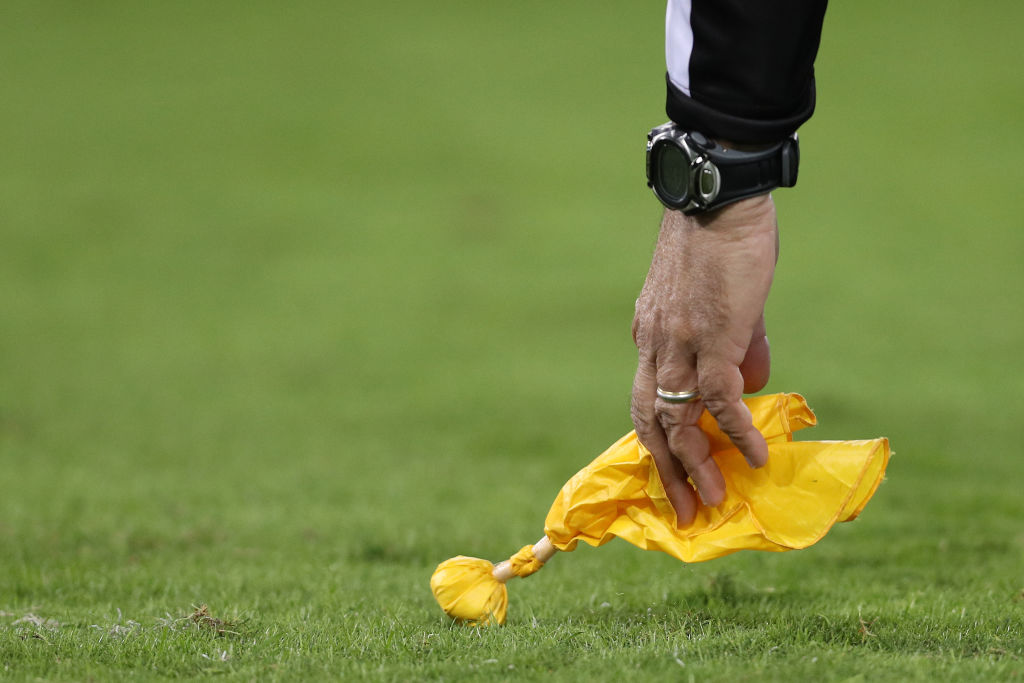 NFL referees signal penalties with a yellow flag.