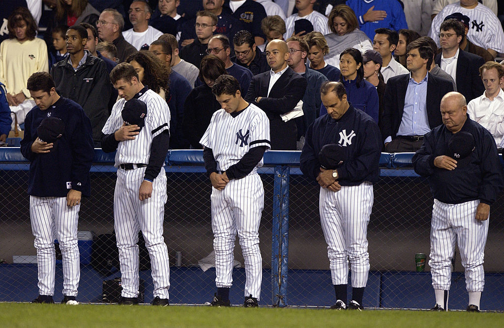 On the one year anniversary of September 11, 2001, members of the New York Yankees bow their heads to observe a moment of silence
