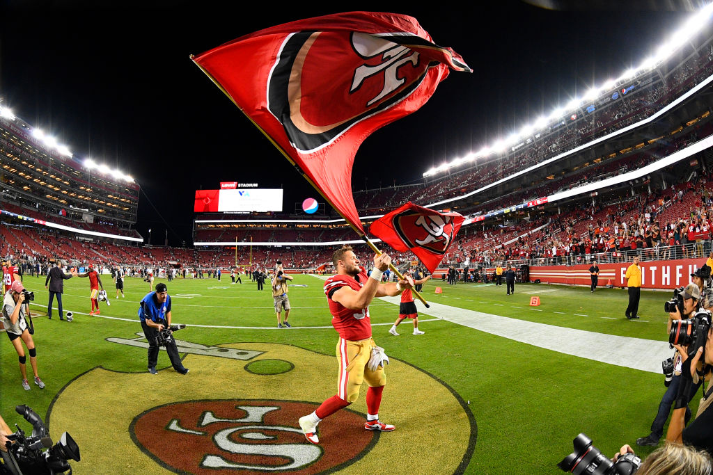 San Francisco 49ers Defensive End Nick Bosa (97) waves the flag