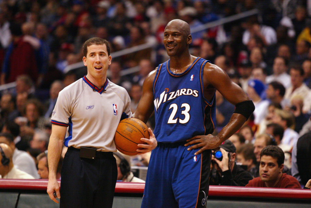NBA referee Tim Donaghy chats with Michael Jordan during a game.