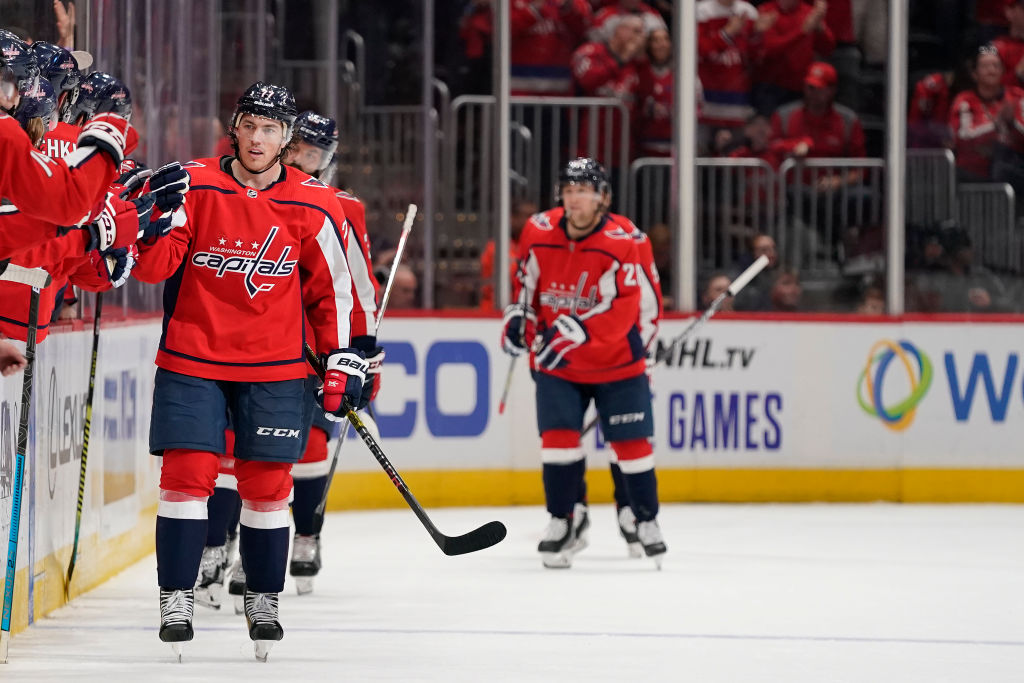 The Washington Capitals exchange high-fives with the bench.